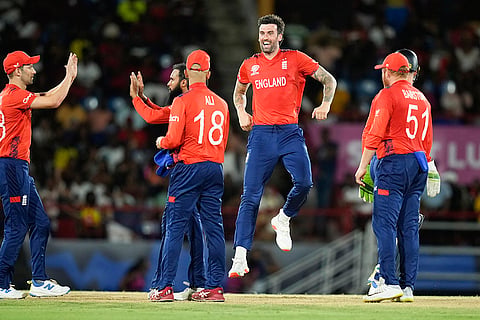 England players celebrate Andre Russell's wicket